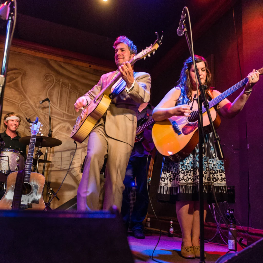 Black Lillies' Cruz Contreras and Trisha Gene Brady accompany one another as drummer Bowman Townsend looks on at Saturday's OPRF Food Pantry benefit concert at Fitzgerald's.