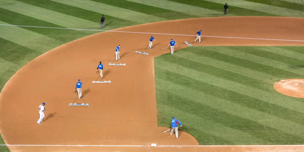 CHICAGO, IL - APRIL 5: The grounds crew sweeps the base paths during the Opening Night game against the St. Louis Cardinals at Wrigley Field on Sunday, April 5, 2015 in Chicago, Illinois. (Photo by Matt Kosterman/MLB Photos via Getty Images)