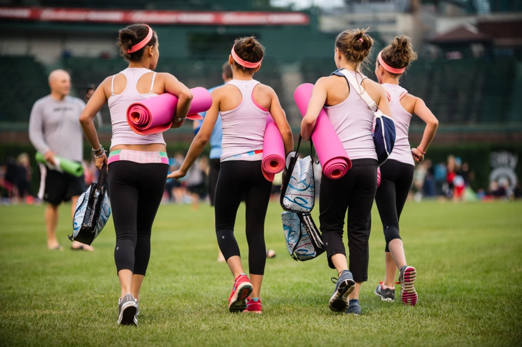 Four young girls scouting the best place to put their mats for a Lululemon-sponsored yoga class at Wrigley Field in July 2013.