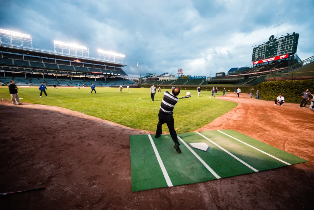 A guest of CDW hits a big one during the softball game at the CDW VIP outing at Wrigley Field, Chicago, Illinois.