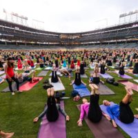 Hundreds of people doing yoga on Wrigley Field with Lululemon